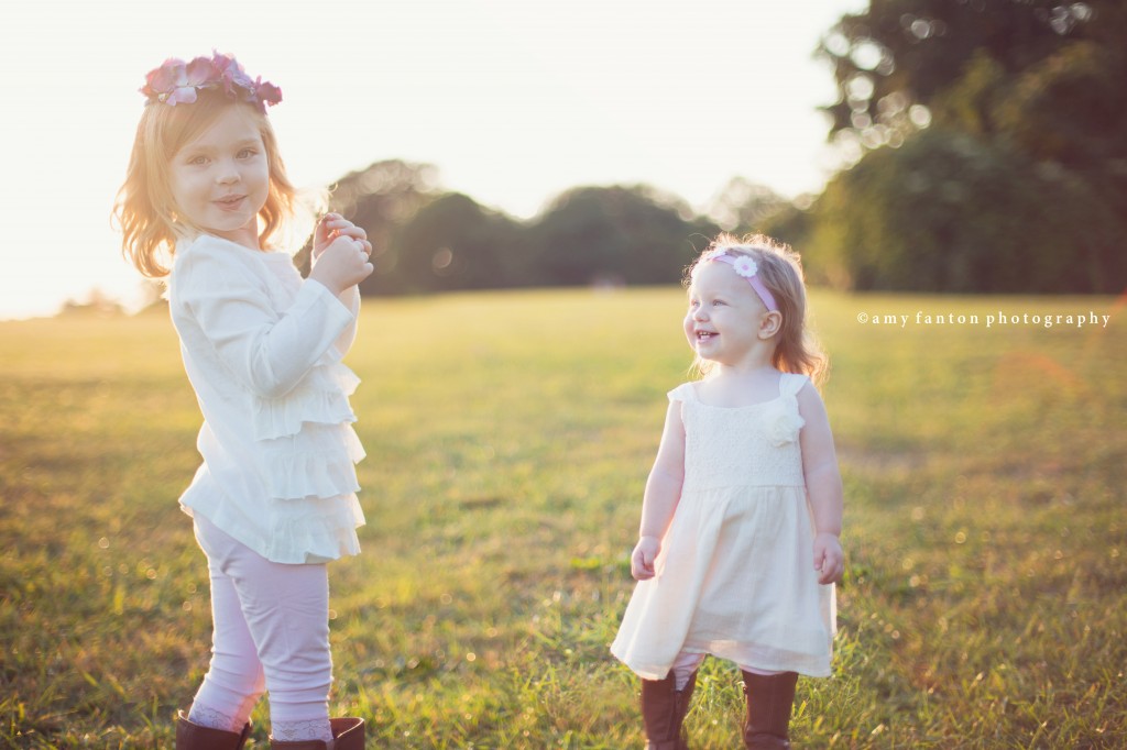 Sisters playing in field